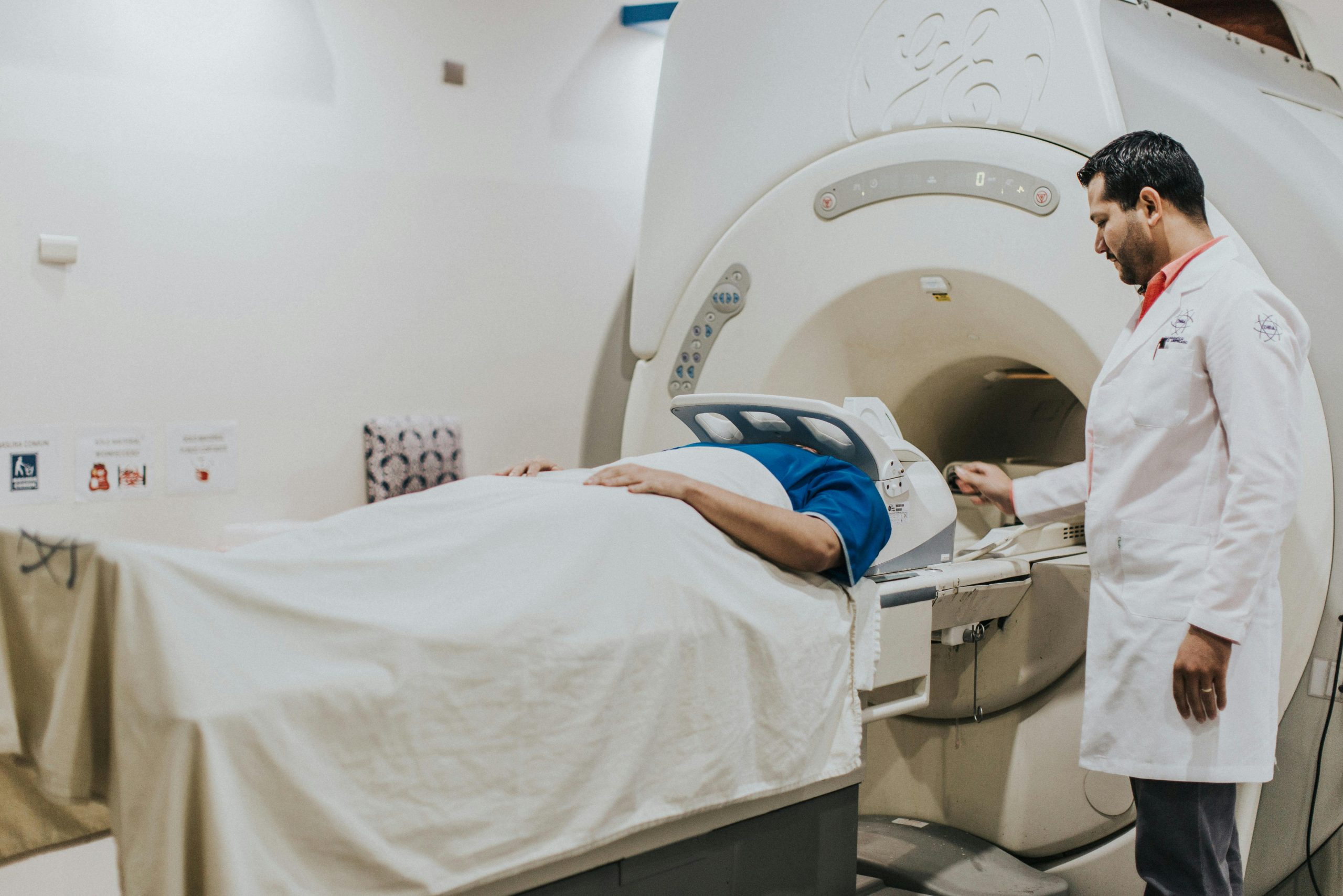 An imaging professional helping someone during an MRI scan, used to explain MRI claustrophobia